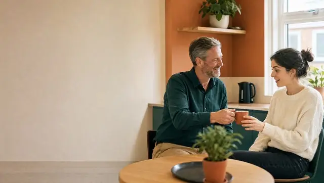 AI image: a colleague hands a new colleague a coffee in the office kitchen – the first day at work.