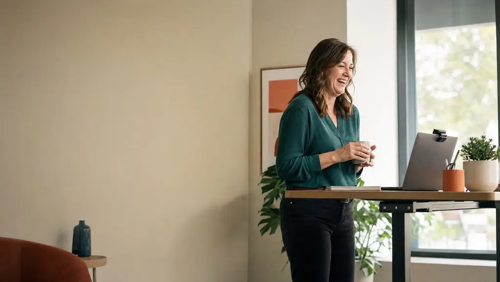 AI image: a woman laughs at her laptop – small talk just before an online meeting.